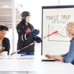 Colleague enjoys tasty glass of maple syrup during presentation by hockey player - Photo by Canadian Internet Registration Authority (CIRA)